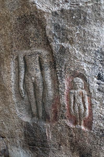 Cave wall carved with figure of Jain Tirthankara Adinatha